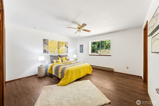 10320 46th Ave SE, Olympia, WA 98513 - bedroom featuring a baseboard radiator, dark wood-type flooring, a textured ceiling, and ceiling fan
