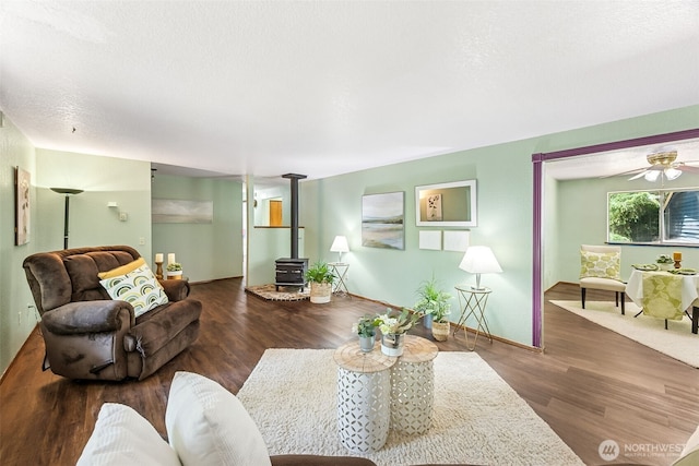 10320 46th Ave SE, Olympia, WA 98513 - living room with a wood stove, wood finished floors, and ceiling fan