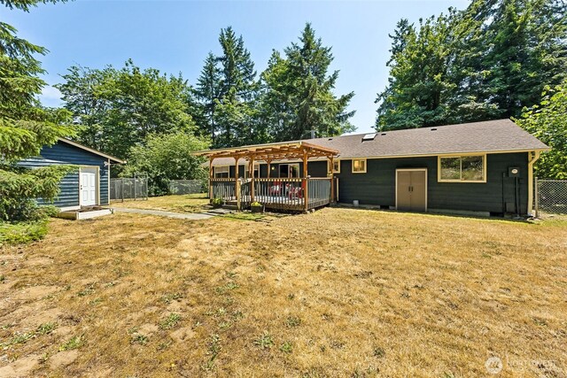 10320 46th Ave SE, Olympia, WA 98513 - rear view of house featuring a deck, a fenced backyard, a pergola, and a shed