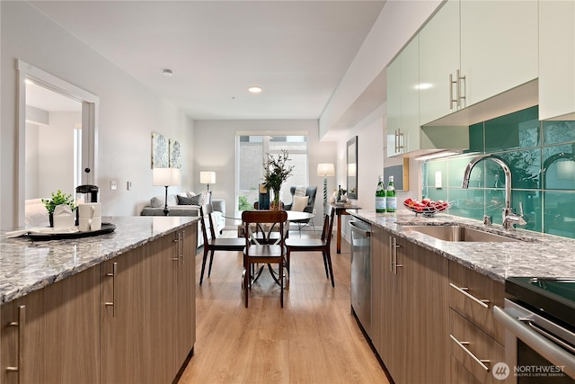 1085 103rd Ave NE Unit 203, Bellevue, WA 98004 - kitchen featuring a sink, light wood-style floors, light stone counters, open floor plan, and recessed lighting
