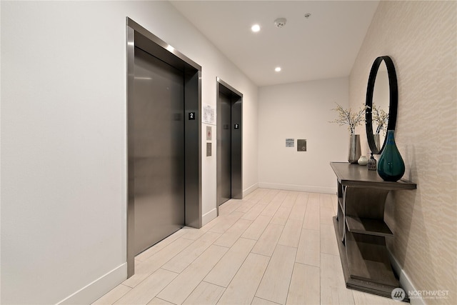 1085 103rd Ave NE Unit 203, Bellevue, WA 98004 - hall featuring elevator, recessed lighting, light wood-type flooring, and baseboards