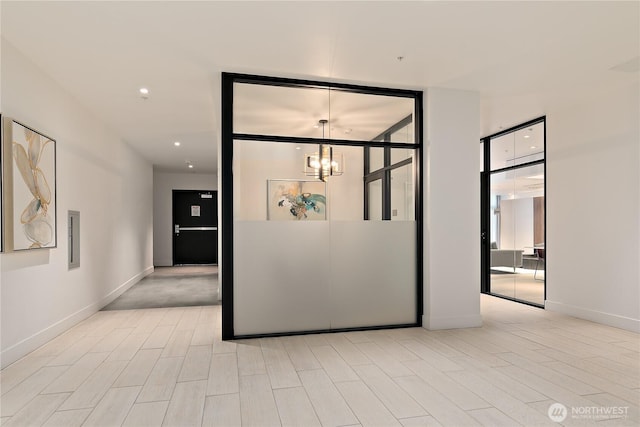 1085 103rd Ave NE Unit 203, Bellevue, WA 98004 - unfurnished room with a chandelier, baseboards, and wood finished floors