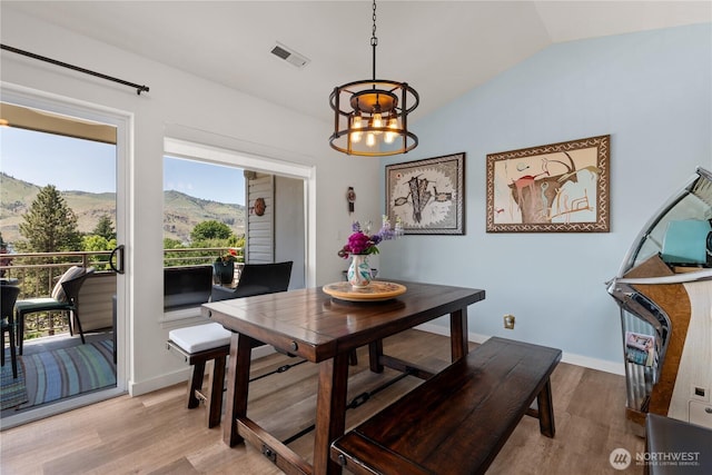 808 W Manson Rd Unit B303, Chelan, WA 98816 - dining room featuring a chandelier, light wood finished floors, a mountain view, healthy amount of natural light, and lofted ceiling