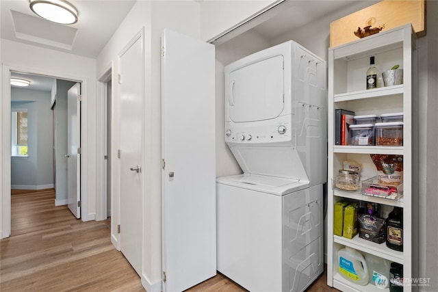 808 W Manson Rd Unit B303, Chelan, WA 98816 - washroom featuring stacked washer and clothes dryer, light wood-type flooring, and baseboards