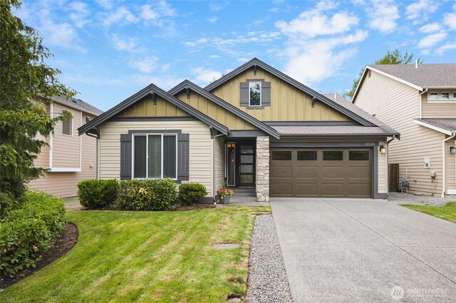 35681 30th Ave S, Federal Way, WA 98003 - view of front facade featuring board and batten siding, an attached garage, concrete driveway, and a front yard