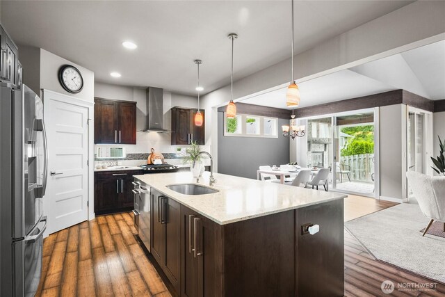 35681 30th Ave S, Federal Way, WA 98003 - kitchen with stainless steel refrigerator with ice dispenser, a sink, wall chimney exhaust hood, wood finished floors, and recessed lighting