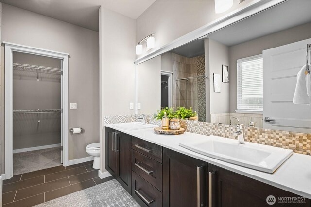 35681 30th Ave S, Federal Way, WA 98003 - full bathroom with a shower stall, toilet, double vanity, a spacious closet, and baseboards