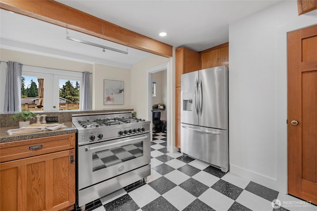 1814 SW 347th Pl, Federal Way, WA 98023 - kitchen featuring stainless steel appliances, light flooring, tile countertops, brown cabinetry, and baseboards