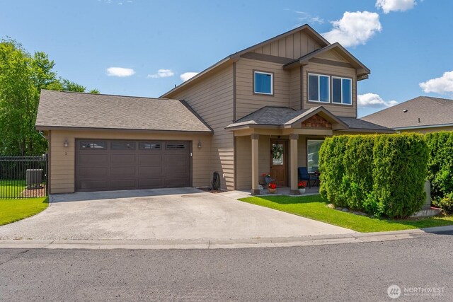 1300 W Marina Dr Unit 1, Moses Lake, WA 98837 - view of front of property with driveway, a garage, central air condition unit, and roof with shingles