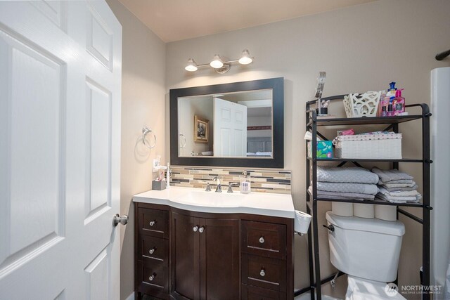 1300 W Marina Dr Unit 1, Moses Lake, WA 98837 - bathroom with tasteful backsplash, vanity, and toilet