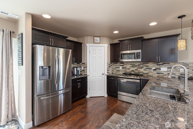 1300 W Marina Dr Unit 1, Moses Lake, WA 98837 - kitchen featuring appliances with stainless steel finishes, a sink, dark brown cabinets, dark wood-style floors, and recessed lighting