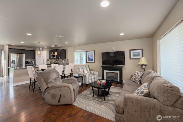 1300 W Marina Dr Unit 1, Moses Lake, WA 98837 - living area featuring dark wood-style flooring, recessed lighting, baseboards, and a fireplace