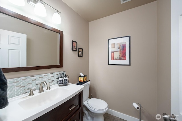 1300 W Marina Dr Unit 1, Moses Lake, WA 98837 - half bathroom featuring toilet, backsplash, vanity, tile patterned floors, and baseboards