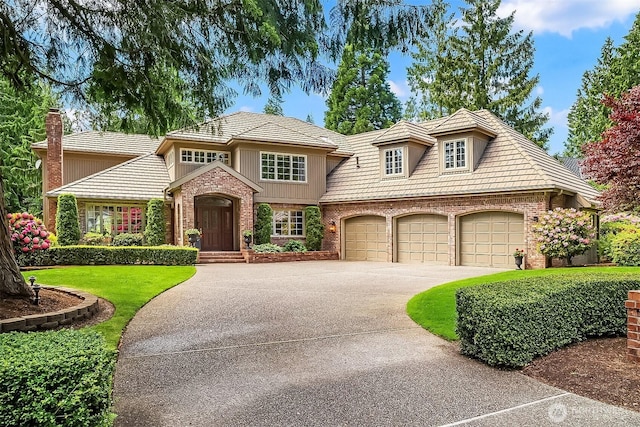 2805 Sahalee Dr E, Sammamish, WA 98074 - english style home featuring concrete driveway, a front lawn, brick siding, and a garage