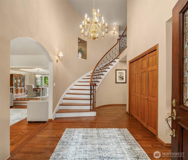 2805 Sahalee Dr E, Sammamish, WA 98074 - foyer featuring a high ceiling, arched walkways, wood finished floors, stairs, and a chandelier