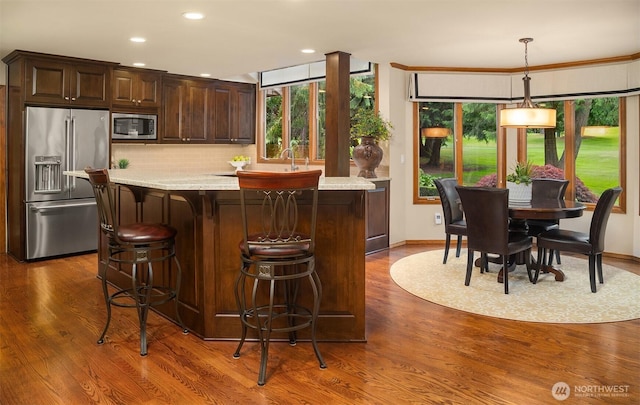 2805 Sahalee Dr E, Sammamish, WA 98074 - kitchen with appliances with stainless steel finishes, healthy amount of natural light, dark brown cabinets, dark wood finished floors, and recessed lighting