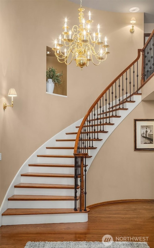 2805 Sahalee Dr E, Sammamish, WA 98074 - staircase featuring wood finished floors, a high ceiling, and a chandelier