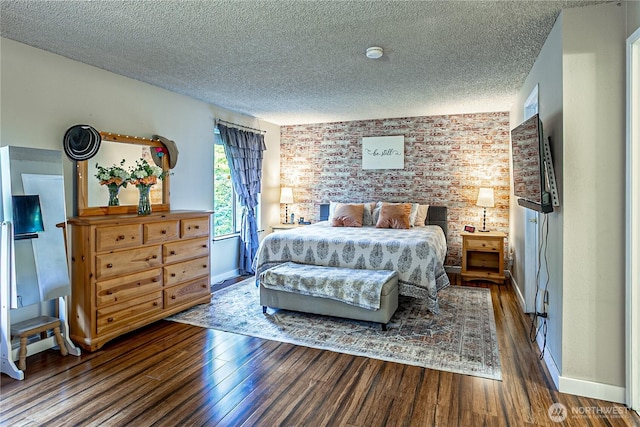 5613 89th Ave W, University Place, WA 98467 - bedroom with a textured ceiling, brick wall, wood finished floors, and baseboards
