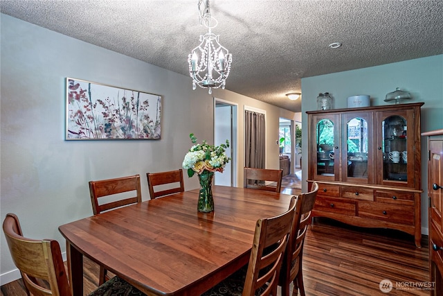 5613 89th Ave W, University Place, WA 98467 - dining room featuring a chandelier, a textured ceiling, and wood finished floors