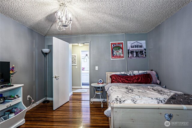 5613 89th Ave W, University Place, WA 98467 - bedroom with wood finished floors, a textured ceiling, and baseboards
