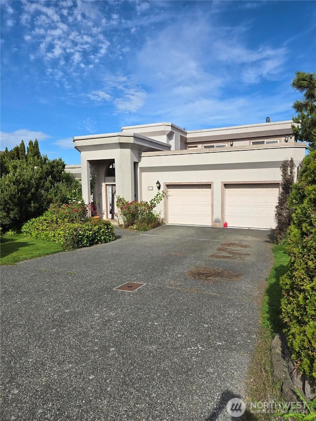 8122 Coquitlam Pl, Blaine, WA 98230 - view of front of home featuring stucco siding, a garage, and asphalt driveway