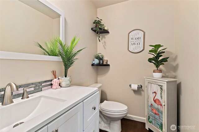813 SW 363rd Pl, Federal Way, WA 98023 - half bathroom featuring toilet, vanity, wood finished floors, and baseboards