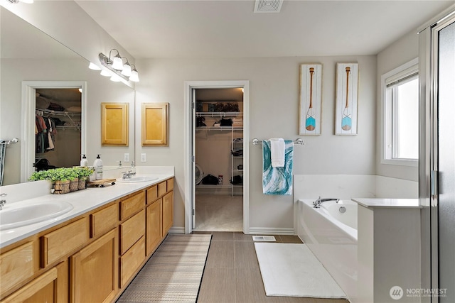 813 SW 363rd Pl, Federal Way, WA 98023 - full bathroom with a walk in closet, double vanity, a bath, and tile patterned floors