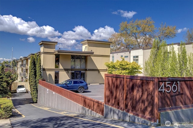 4561 Lake Washington Blvd NE Unit 303, Kirkland, WA 98033 - view of building exterior with uncovered parking