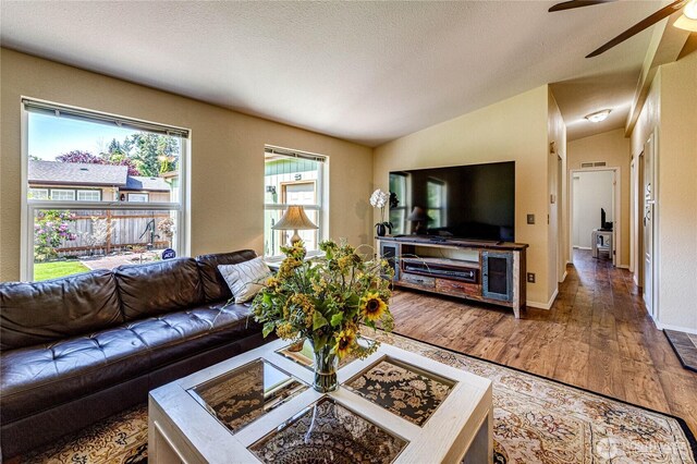 300 Fircrest Dr, Sequim, WA 98382 - living room with ceiling fan, wood finished floors, vaulted ceiling, and baseboards