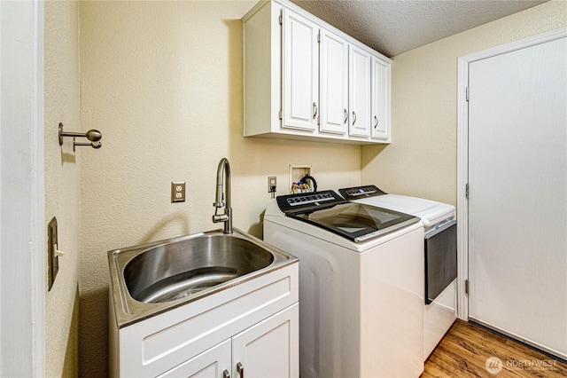 300 Fircrest Dr, Sequim, WA 98382 - laundry area with cabinet space, separate washer and dryer, light wood-type flooring, and a textured ceiling