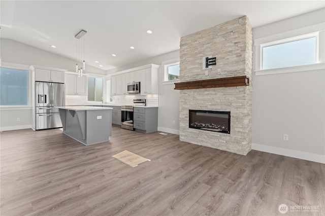 200 Pinnacle Pl, Chelan, WA 98816 - kitchen featuring stainless steel appliances, white cabinets, light countertops, tasteful backsplash, and lofted ceiling