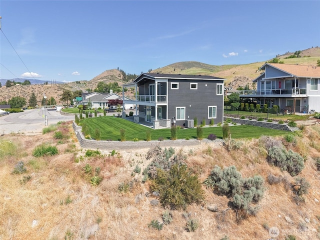 200 Pinnacle Pl, Chelan, WA 98816 - rear view of house with a mountain view, central air condition unit, a balcony, and a lawn