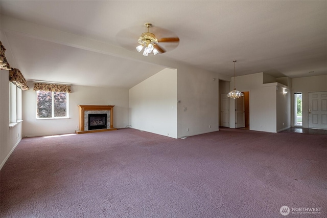 580 Canyon Dr, East Wenatchee, WA 98802 - unfurnished living room with carpet floors, a ceiling fan, a fireplace with raised hearth, plenty of natural light, and lofted ceiling