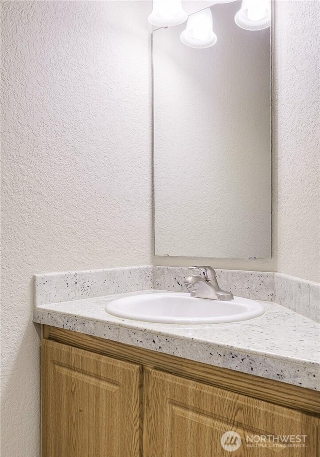 13145 102nd Ln NE Unit 5, Kirkland, WA 98034 - bathroom featuring vanity and a textured wall