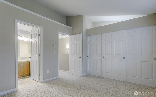13145 102nd Ln NE Unit 5, Kirkland, WA 98034 - unfurnished bedroom featuring light colored carpet, vaulted ceiling, a closet, baseboards, and ensuite bath