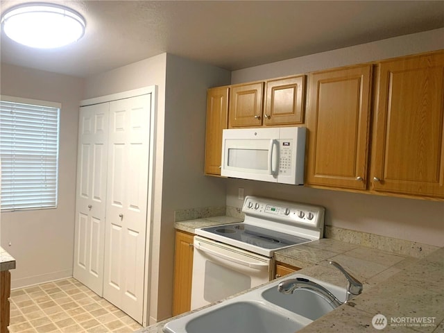 13145 102nd Ln NE Unit 5, Kirkland, WA 98034 - kitchen featuring white appliances, light countertops, baseboards, and a sink