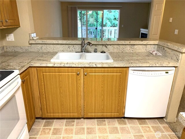 13145 102nd Ln NE Unit 5, Kirkland, WA 98034 - kitchen with white appliances, a sink, tile counters, brown cabinets, and a peninsula
