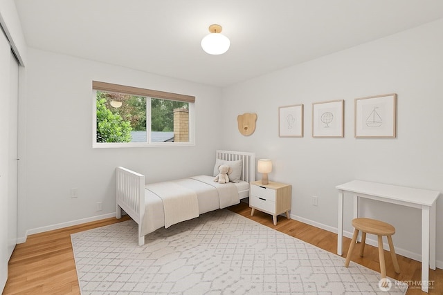 1030 145th Pl SE, Bellevue, WA 98007 - bedroom with light wood-style flooring and a closet