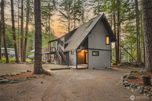 17118 Riverview Way E, Enumclaw, WA 98022 - view of front of property with roof with shingles, stairs, a wooden deck, and crawl space