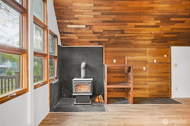 17118 Riverview Way E, Enumclaw, WA 98022 - unfurnished living room featuring a wood stove, wood finished floors, wood walls, wooden ceiling, and high vaulted ceiling