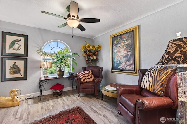 10 E Sunny Sands Rd, Cathlamet, WA 98612 - sitting room featuring wood finished floors, ceiling fan, a textured ceiling, and baseboards