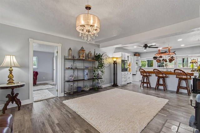 10 E Sunny Sands Rd, Cathlamet, WA 98612 - living area with a textured ceiling, baseboards, healthy amount of natural light, a ceiling fan, and wood finished floors