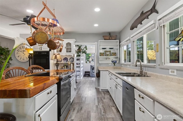10 E Sunny Sands Rd, Cathlamet, WA 98612 - kitchen featuring a sink, appliances with stainless steel finishes, open shelves, white cabinets, and light wood finished floors