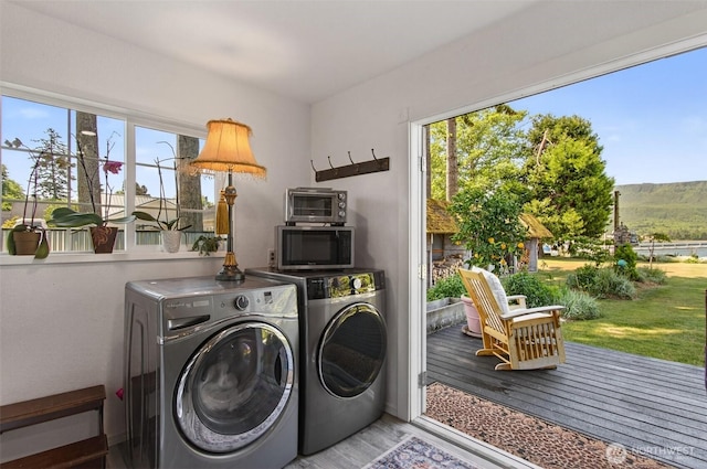 10 E Sunny Sands Rd, Cathlamet, WA 98612 - laundry room featuring wood finished floors and washing machine and clothes dryer