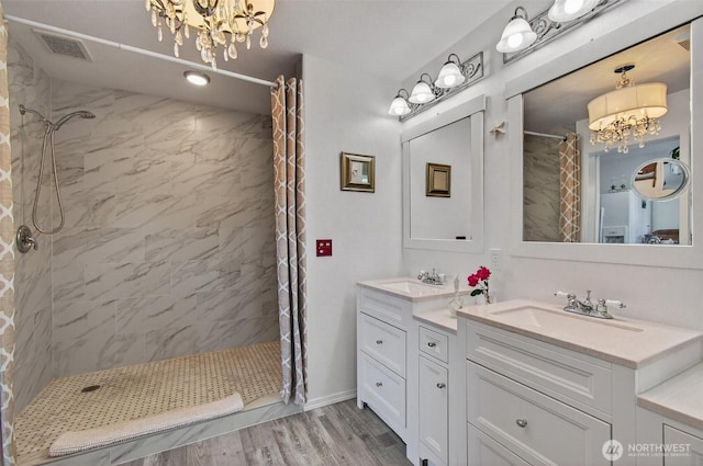 10 E Sunny Sands Rd, Cathlamet, WA 98612 - full bath with a chandelier, tiled shower, vanity, and wood finished floors