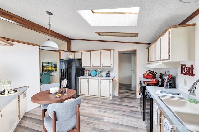 2611 S 288th St Unit 61, Federal Way, WA 98003 - kitchen featuring black fridge with ice dispenser, a skylight, electric range, a textured ceiling, and light countertops