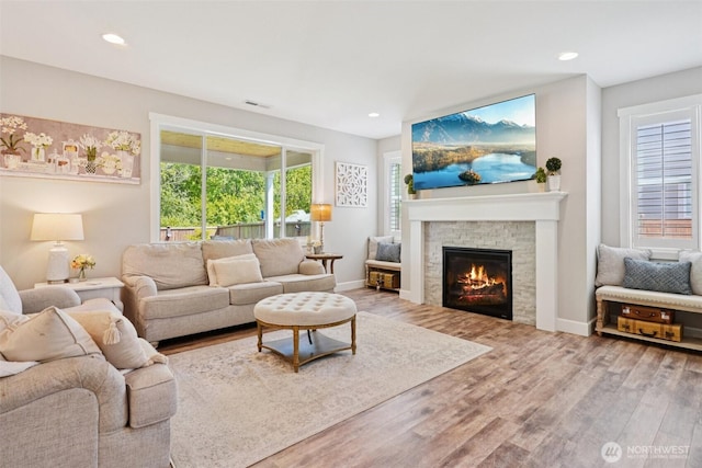 648 S Davis St, Buckley, WA 98321 - living area with wood finished floors, a glass covered fireplace, recessed lighting, and baseboards