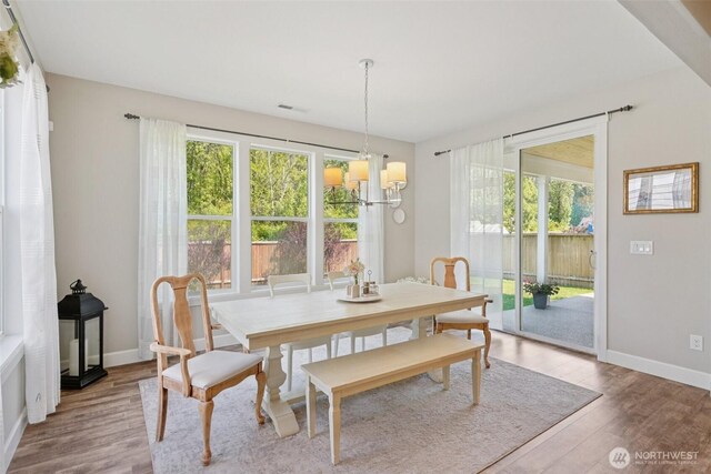 648 S Davis St, Buckley, WA 98321 - dining room with healthy amount of natural light, wood finished floors, baseboards, and a chandelier