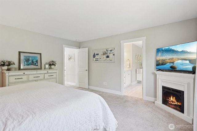 648 S Davis St, Buckley, WA 98321 - bedroom with light carpet, connected bathroom, a warm lit fireplace, and baseboards