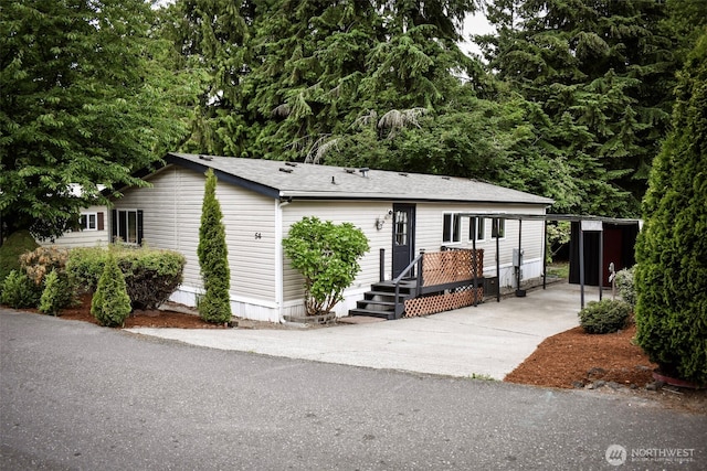 3060 NE Mcwilliams Rd Unit 54, Bremerton, WA 98311 - manufactured / mobile home with concrete driveway and a carport